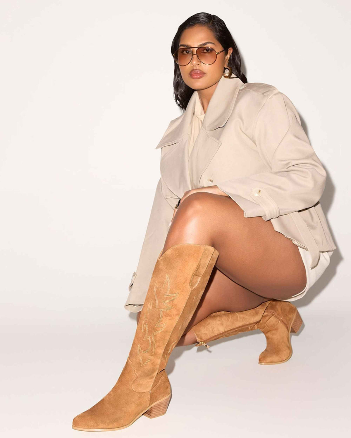 a woman in a white coat and boots