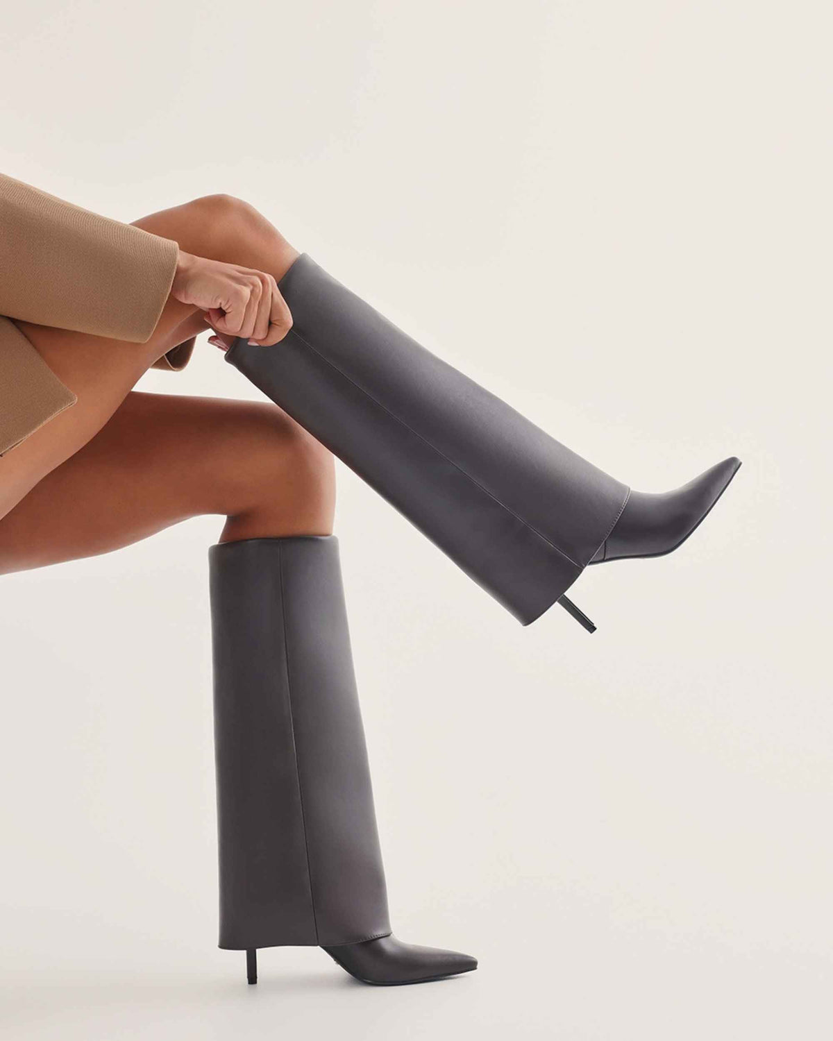 a woman wearing high heel boots