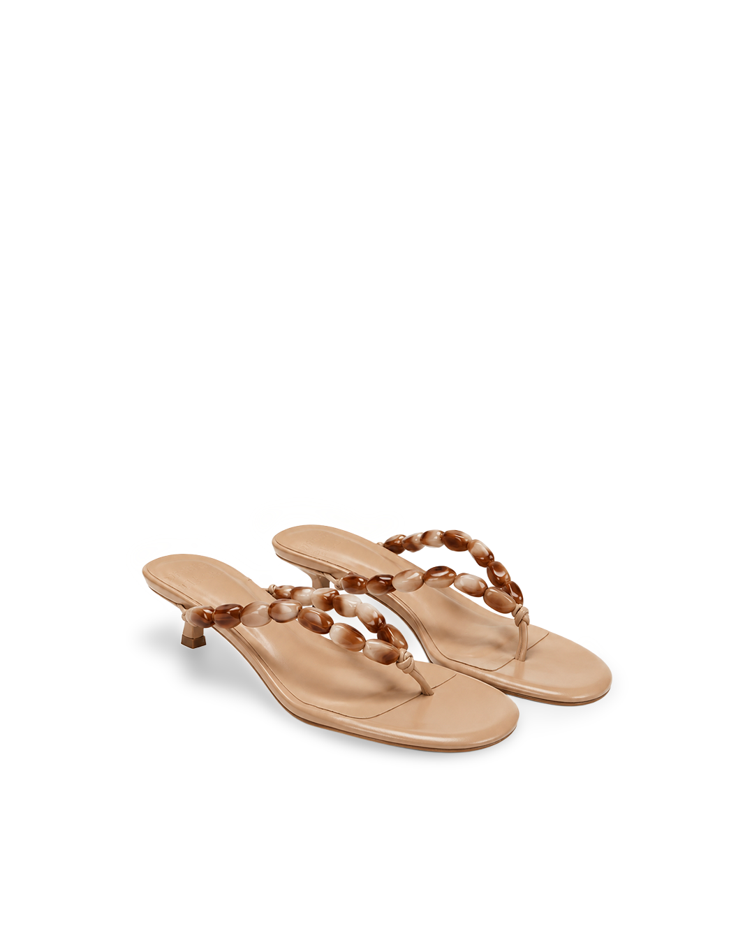 a pair of tan sandals with a beaded design on them