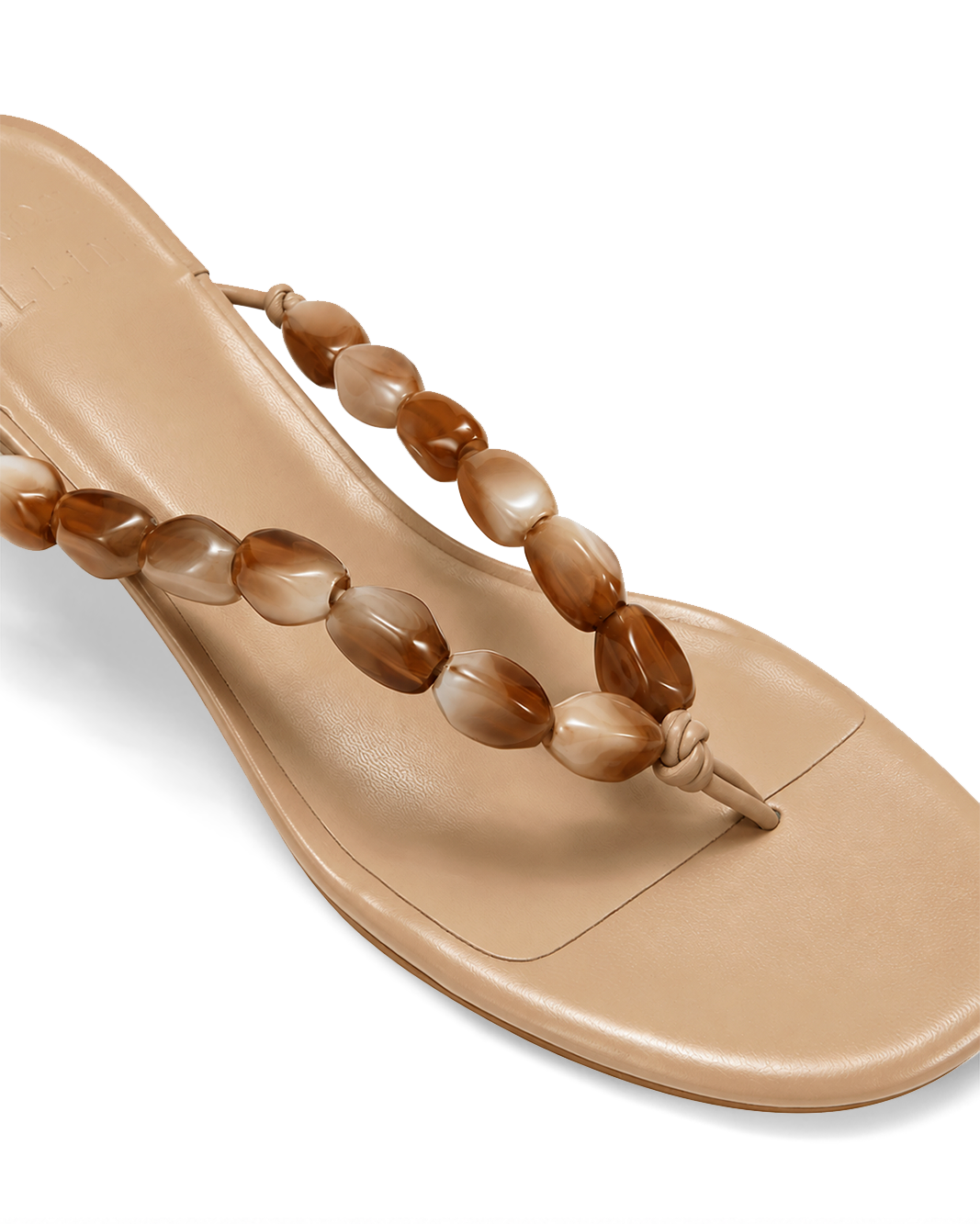 a tan sandal with a beaded strap
