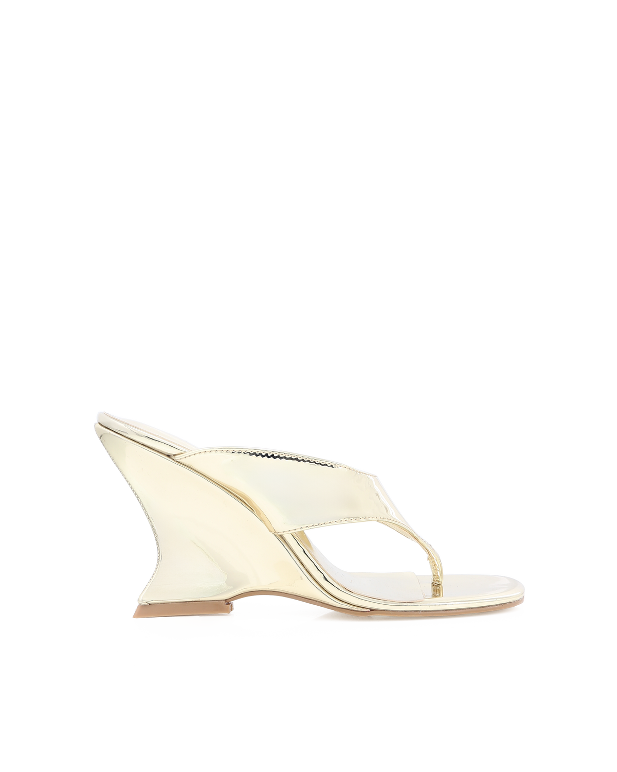 a white wedge sandal with a black background