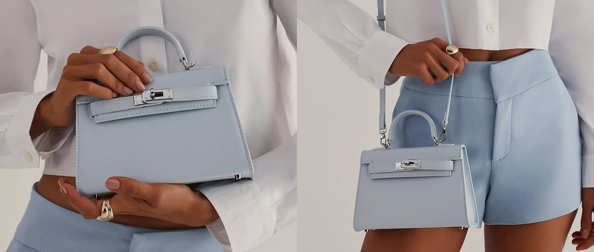 a woman holding a light blue handbag