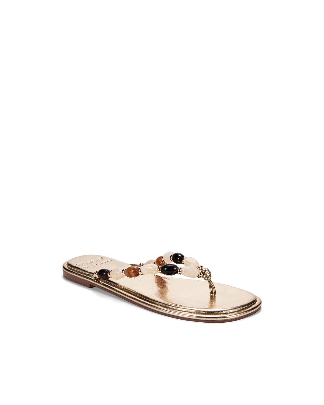 a gold sandal with a beaded strap